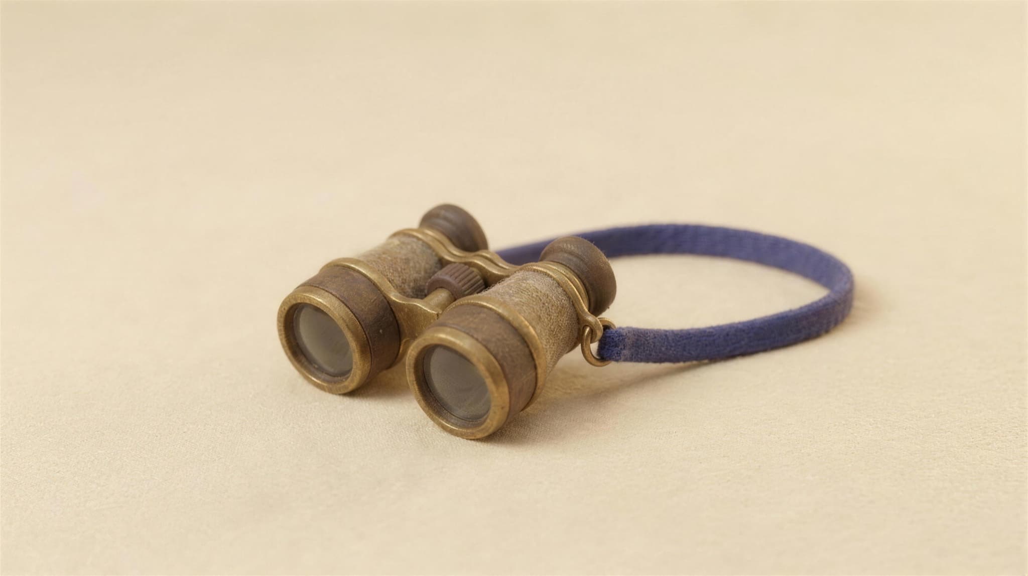 Felted brass binoculars on a flat ground